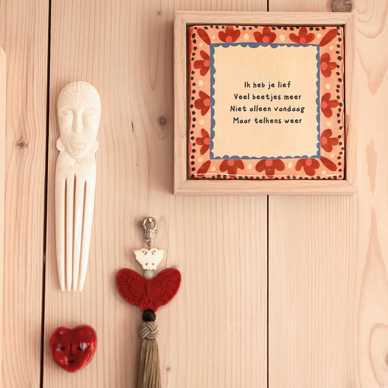 Gepersonaliseerd tegeltje met liefdevolle tekst, op houten muur gepresenteerd