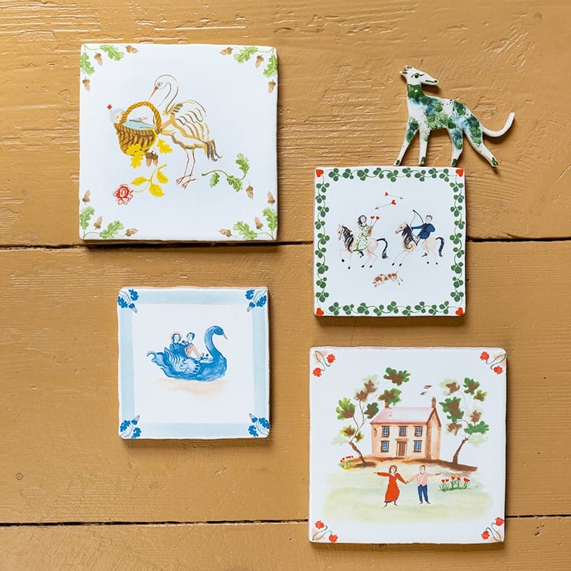 Huwelijkscadeau tegeltjes met diverse decoratieve ontwerpen aan houten wand