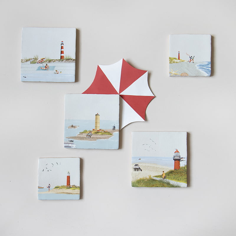 Tegeltjes Texel met vuurtorens en strandscènes aan de muur