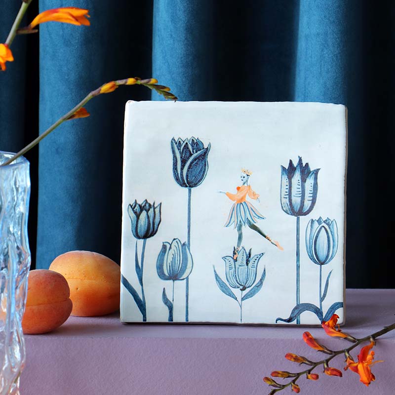 Tegeltje met bloemen en danseres op paarse tafel