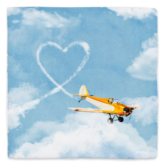 tegeltje vliegtuig schrijft hartje in de lucht