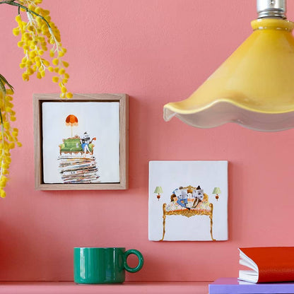 StoryTiles tegeltjes met illustraties van lezende mensen op roze muur gepresenteerd