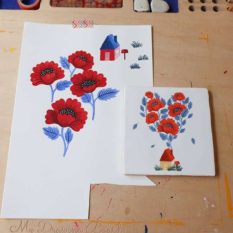 Tegeltje 'Waar liefde is' met rode bloemen en klein huisje op de ontwerptafel