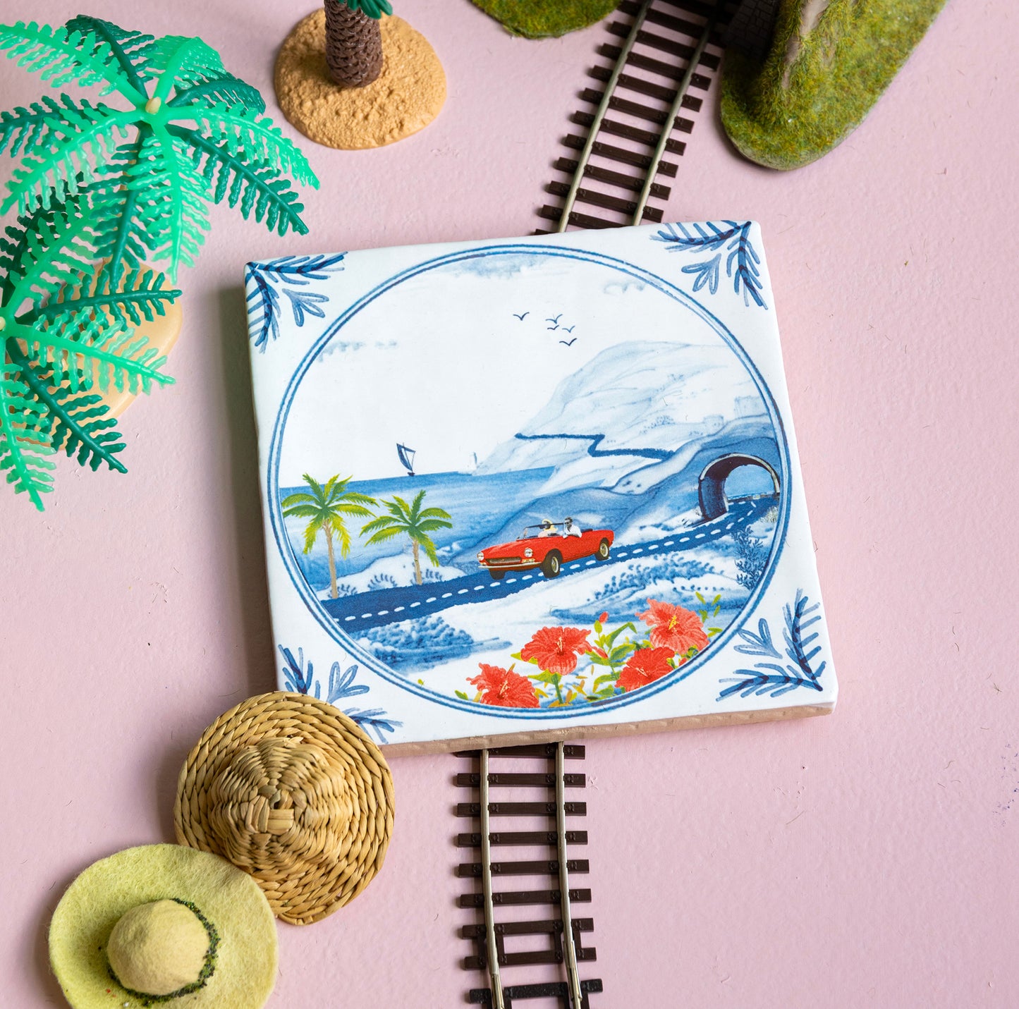 Delfts blauw tegeltje van StoryTiles met rode auto met open dak op road trip