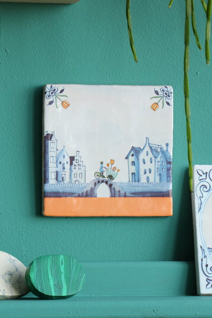 Delfts blauw tulp tegeltje met stadsgezicht, fiets en bloemen, groene muur